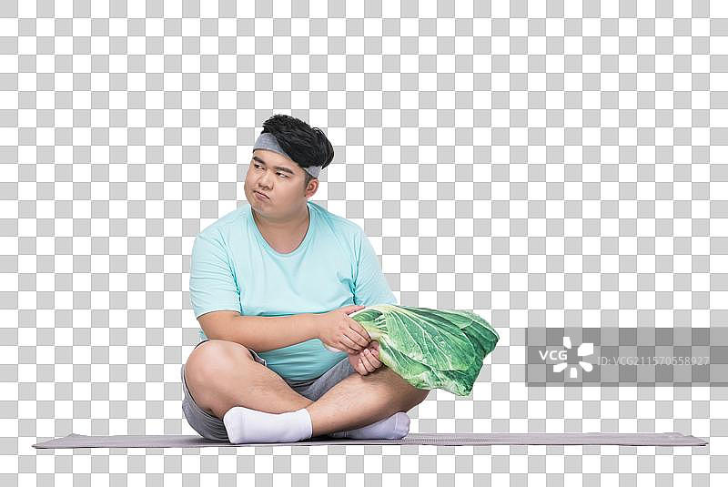 肥胖的青年男子在做运动图片素材