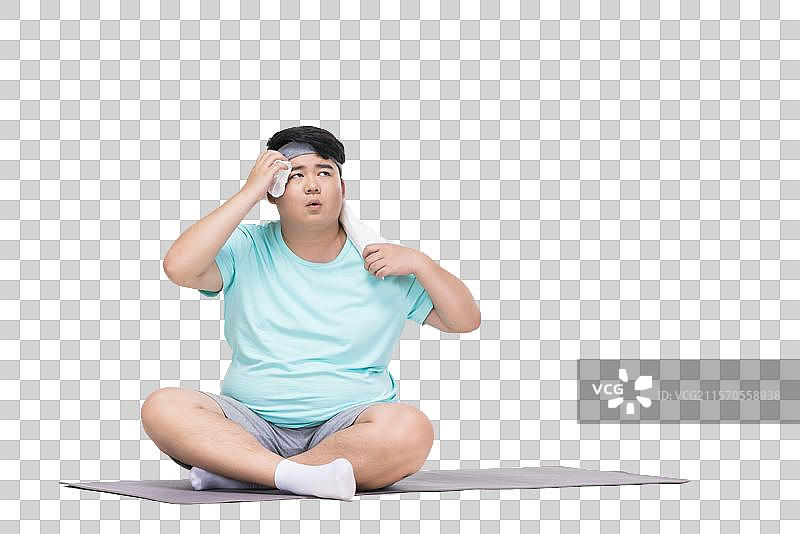肥胖的青年男子在做运动图片素材