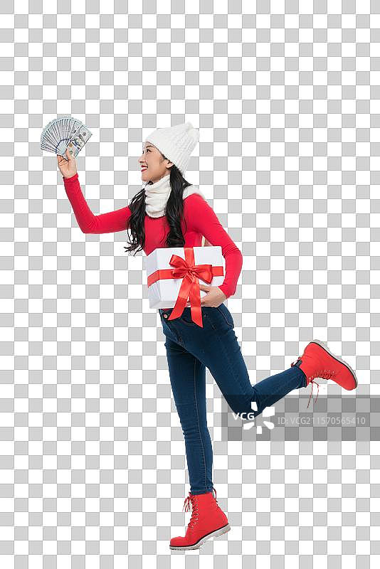 年轻女子拿着礼物和钞票图片素材