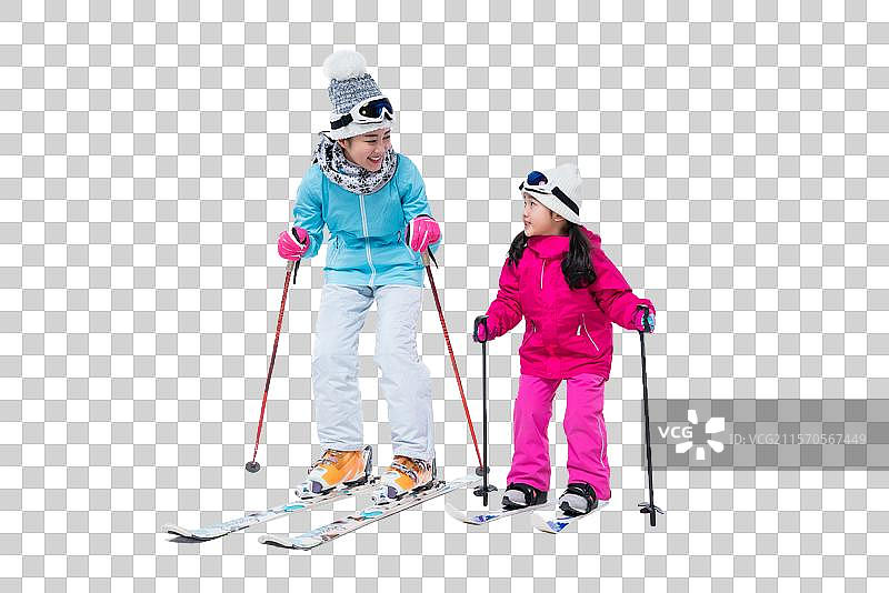 年轻妈妈和女儿滑雪图片素材