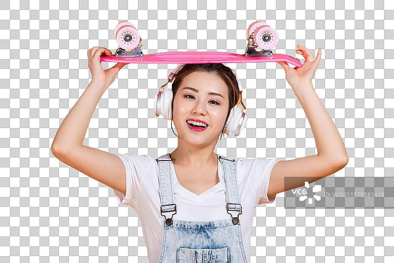 棚拍拿着滑板的年轻女子图片素材