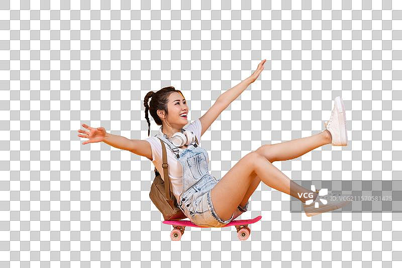 棚拍玩滑板的年轻女子图片素材