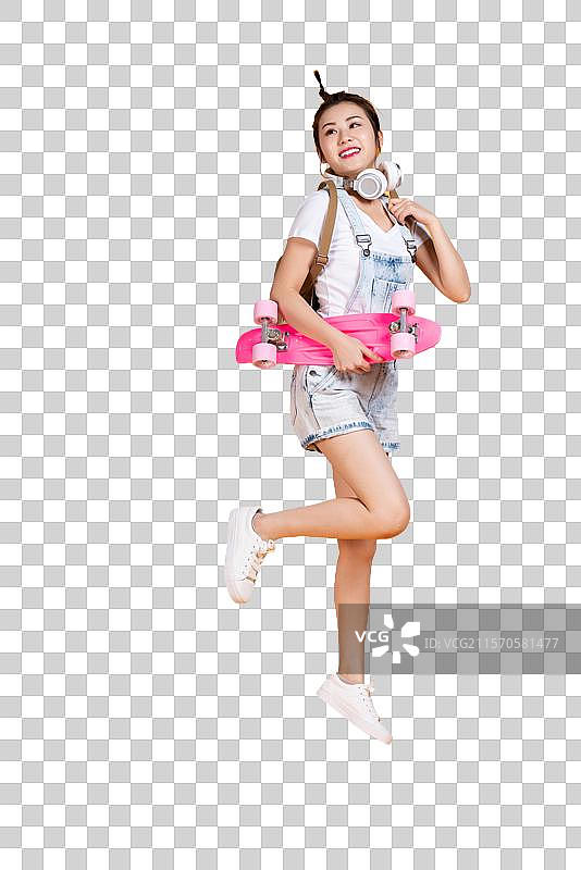 棚拍拿着滑板的年轻女子图片素材