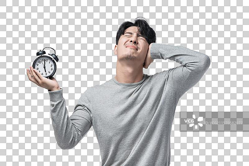 年轻男子拿着闹钟图片素材