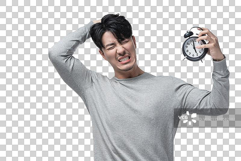 年轻男子拿着闹钟图片素材