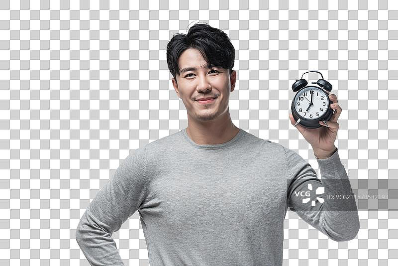 年轻男子拿着闹钟图片素材