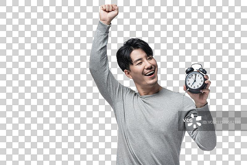 年轻男子拿着闹钟图片素材