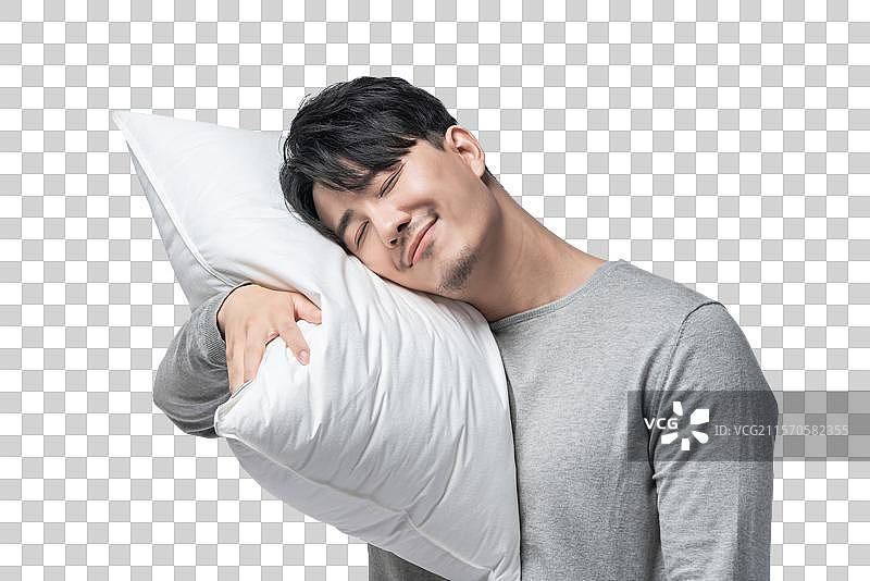 年轻男子拿着枕头图片素材