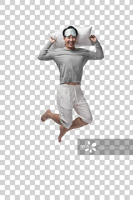 年轻男子拿着枕头图片素材