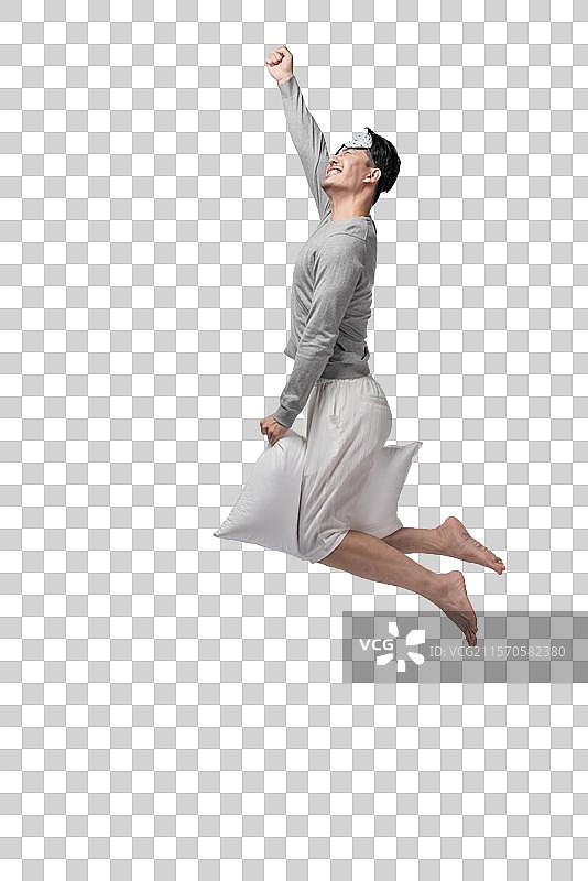 年轻男子拿着枕头图片素材