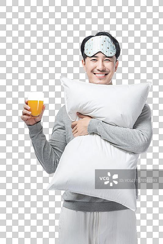 年轻男子拿着枕头图片素材