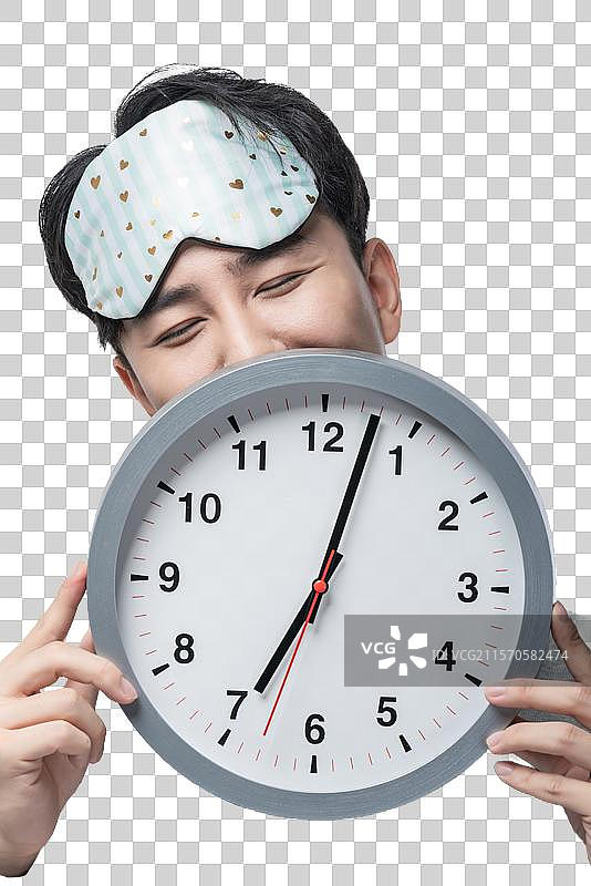 年轻男子拿着钟表图片素材