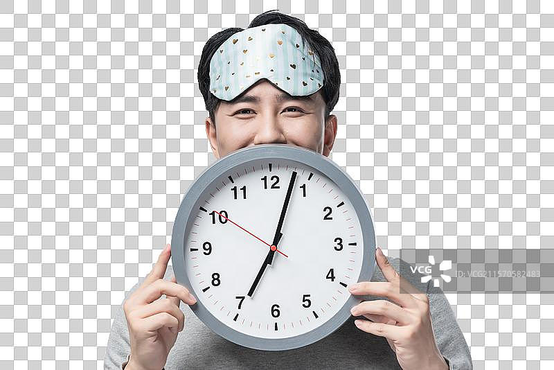 年轻男子拿着钟表图片素材