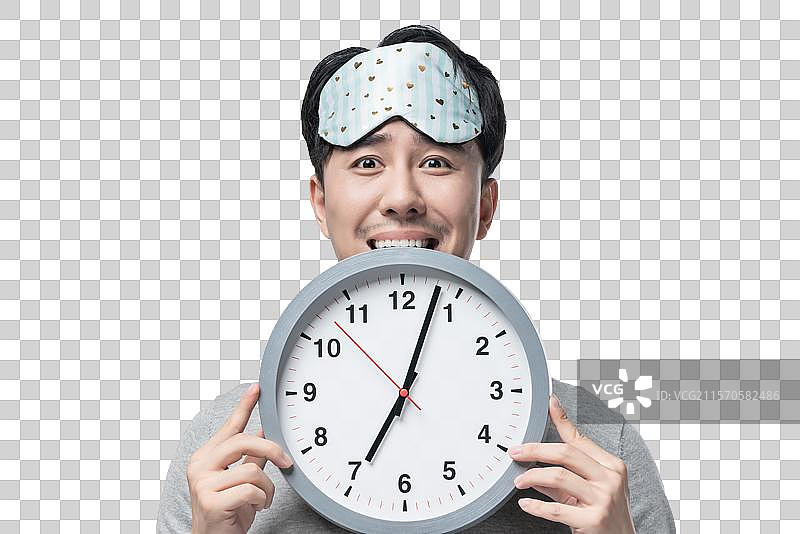 年轻男子拿着钟表图片素材