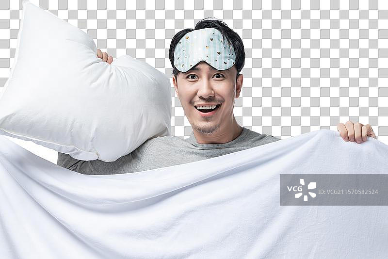 年轻男子拿着被子枕头图片素材