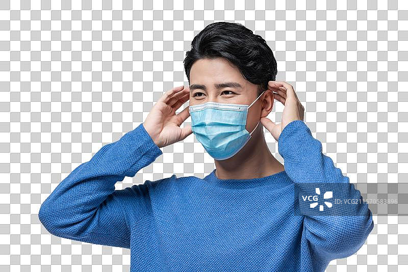 年轻男子拿着外科口罩图片素材