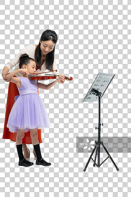 女老师指导女孩演奏乐器图片素材