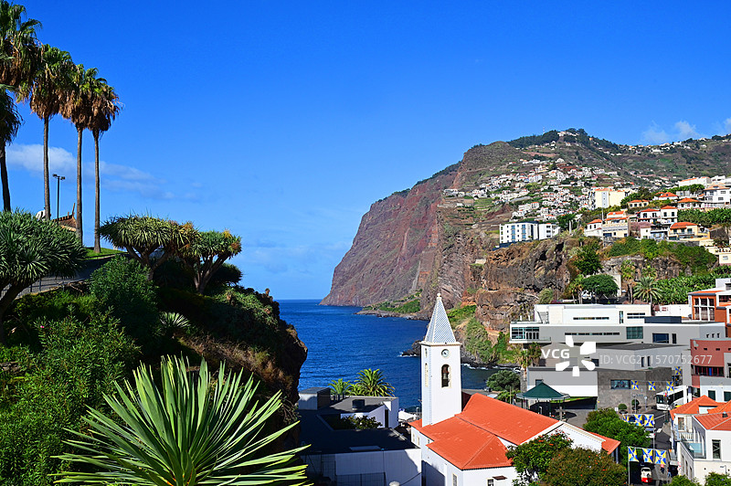 卡马拉德洛博斯村的教堂与岛上最高的卡博吉拉奥悬崖。马德拉岛，葡萄牙。图片素材