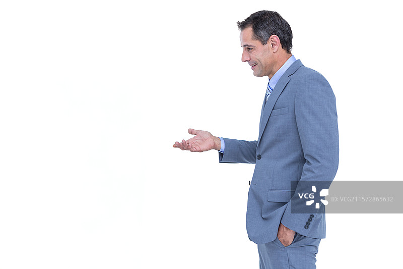身穿蓝色西装的成熟男性侧身站立，手掌向上做出手势，背景留有空白空间图片素材