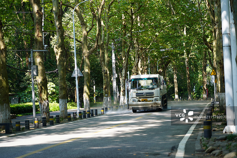 武汉东湖林荫道上的洒水车图片素材