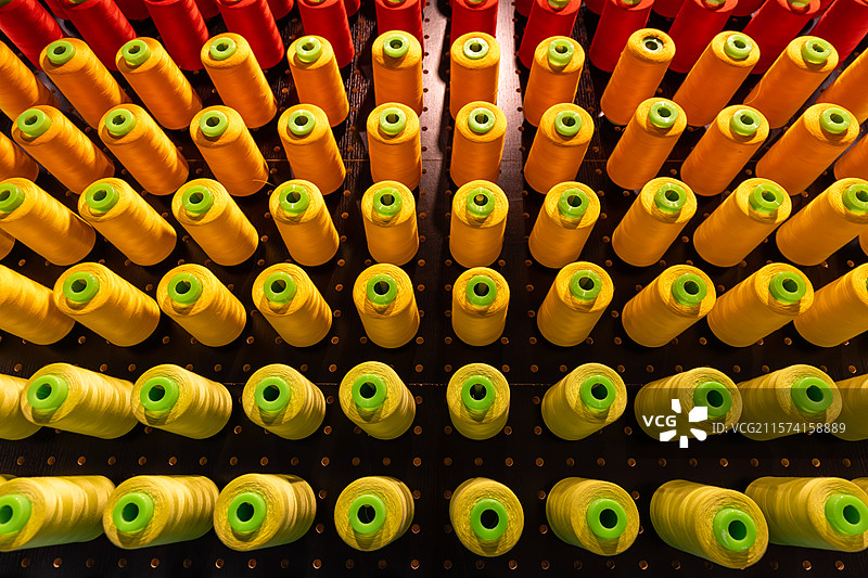 排列整齐色彩鲜艳的纺织线筒展示图片素材