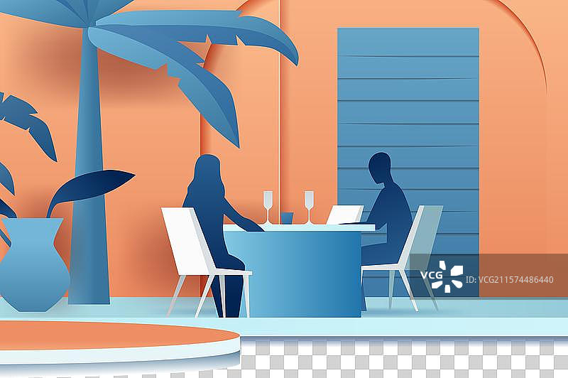 两个人坐在热带环境中的桌子旁图片素材