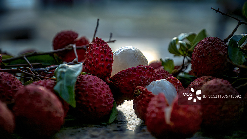带枝叶的桂味荔枝在桌上的开口开果特写镜头图片素材