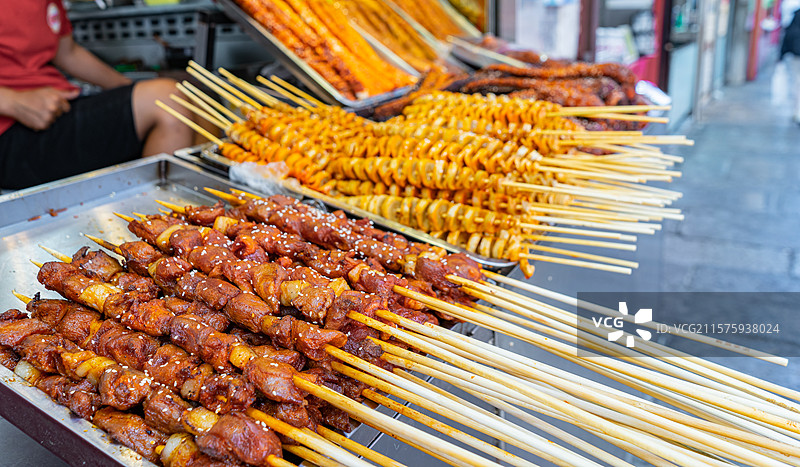 中国饮食产业拍摄主题庙会货摊零售展示，街道货摊烧烤烤羊肉串鸭肉串烤面筋大肠包葱，户外白昼无人图像摄影图片素材