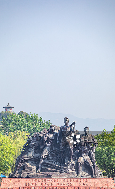 山东泰安泰山天平湖风景区绿水青山背景中的泰山挑山工雕塑建筑特写镜头图片素材
