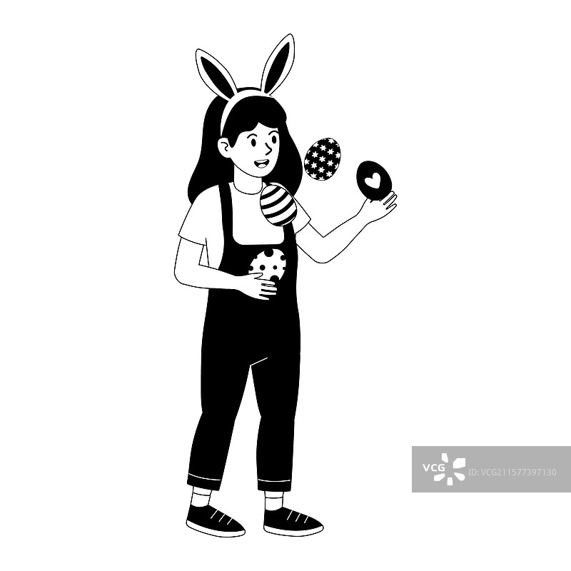 戴着兔耳朵的小孩在玩弄复活节彩蛋图片素材