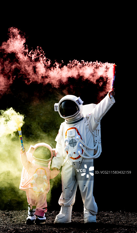 内蒙古乌兰察布乌兰哈达火山地貌火山岩石背景中宇航员服装的男孩女孩游客站在黑色背景下的肖像特写镜头图片素材