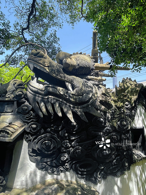 中式古建墙头的精美黑龙龙头龙身雕刻雕塑白墙黑瓦图片素材