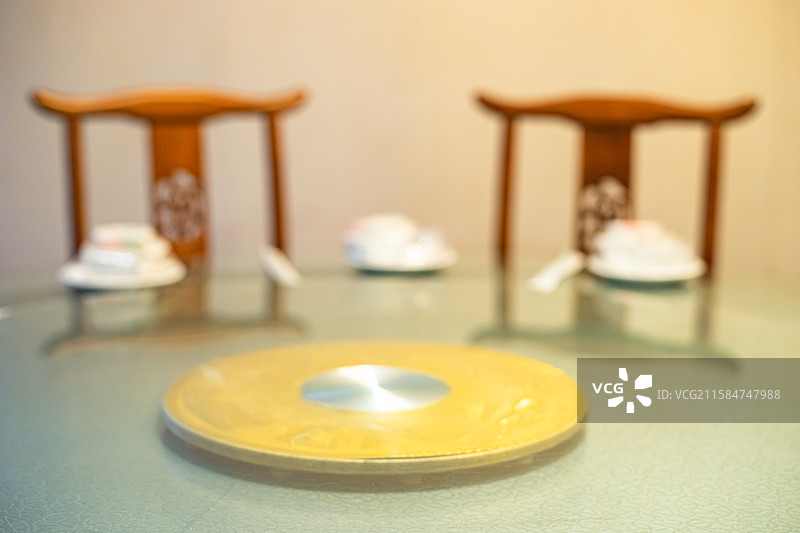 中国餐饮行业，空的餐桌拍摄主题，中国传统木制圆桌上的透明玻璃和餐具，室内无人图像摄影图片素材