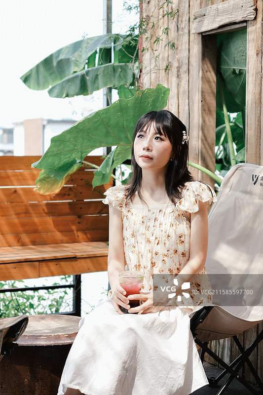 在绿植主题咖啡馆的年轻女性图片素材