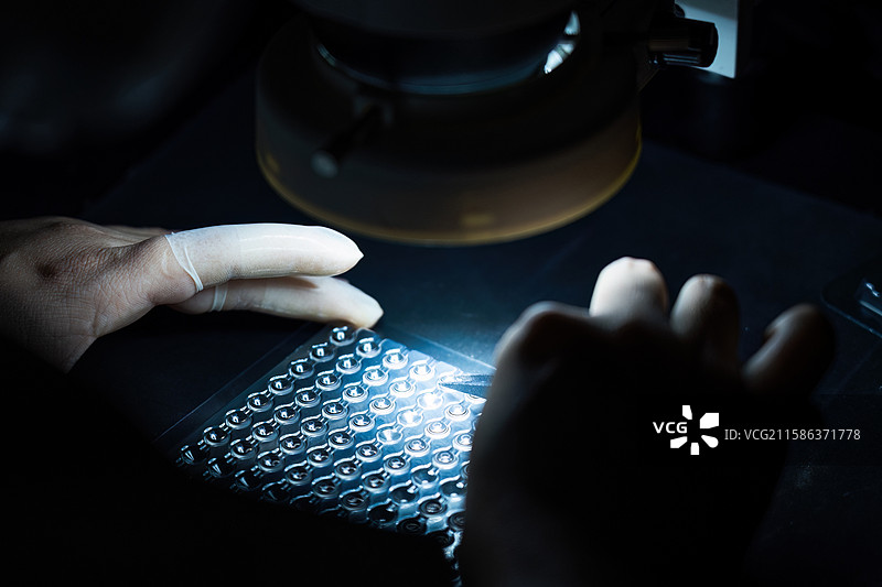 技术人员检查光学镜片特写图片素材
