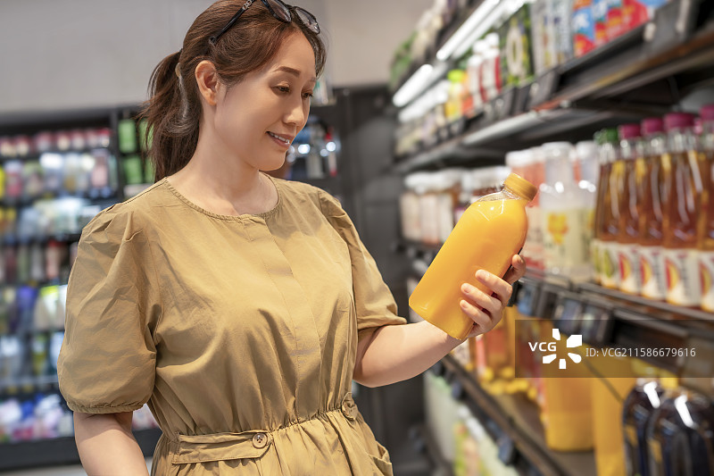 女子在超市选购饮品图片素材