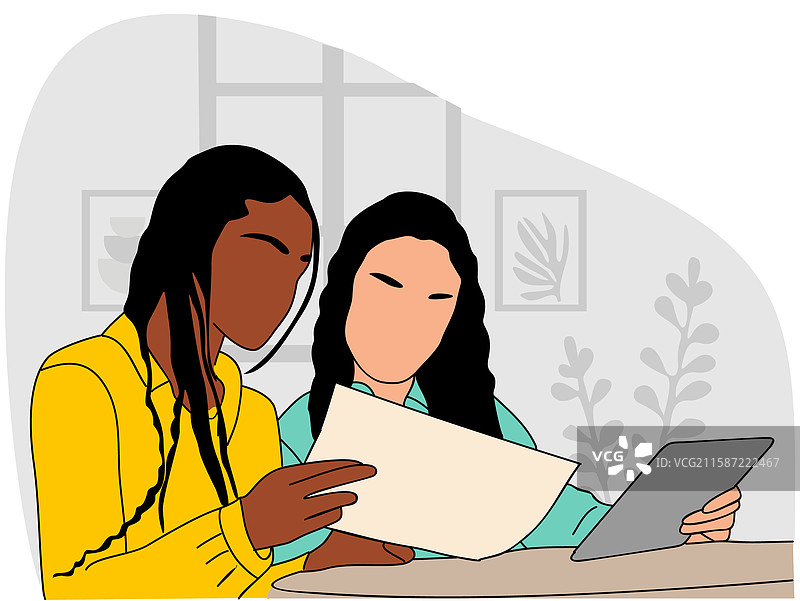 两位女性坐在桌子旁一起工作图片素材