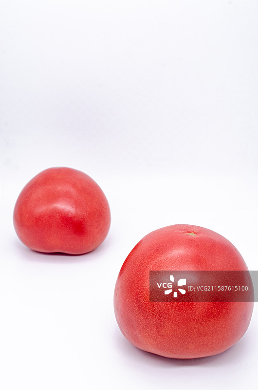 中国传统水果美食饮食产业影棚拍摄主题，白色背景下两个个红色的西红柿番茄，室内无人图像摄影图片素材