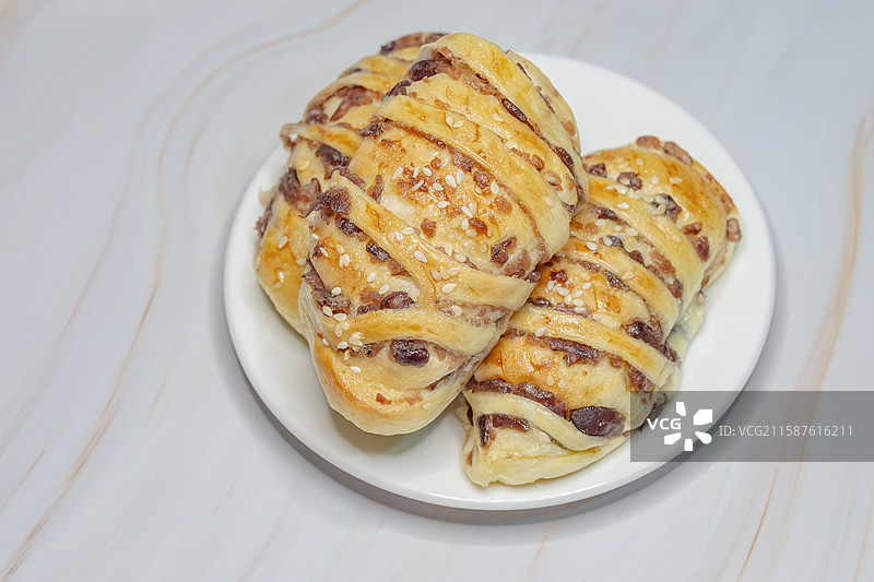 大理石台面上金黄色的烘培面包图片素材