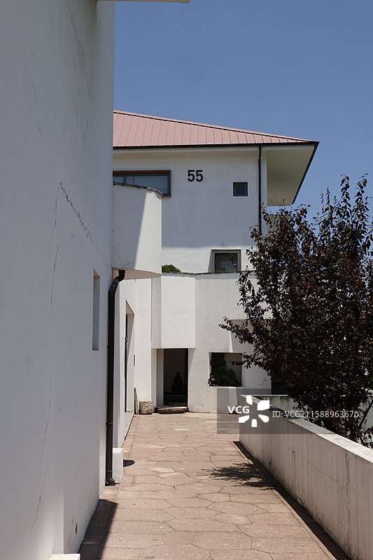 白色建筑旁的石板路与55号标识图片素材