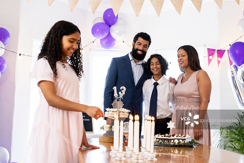 家庭庆祝成人礼，烛光和蛋糕，笑容满面，充满喜悦图片素材