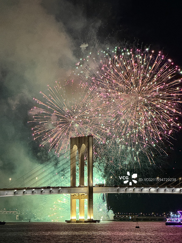 国庆节“澳门回归20年国庆烟花表演”，澳门西湾大桥下的夜间烟花表演的低角度视角图片素材