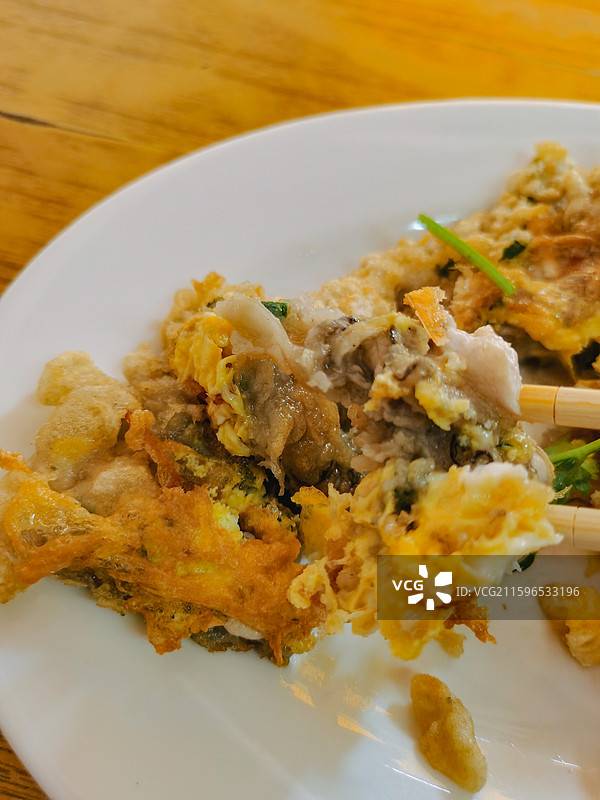 潮州古城潮汕美食蚝烙桌上盘子里食物的特写镜头图片素材