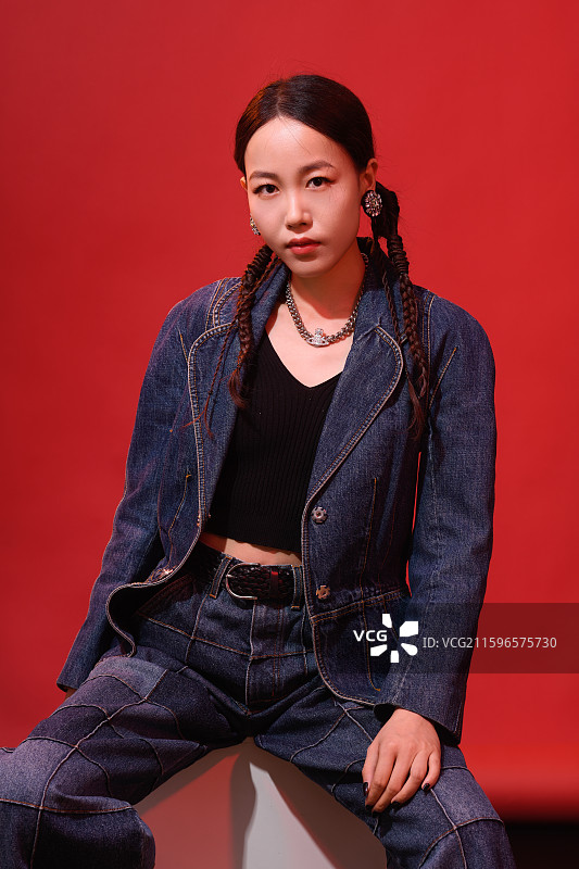 在红色背景下的年轻女子时尚肖像图片素材