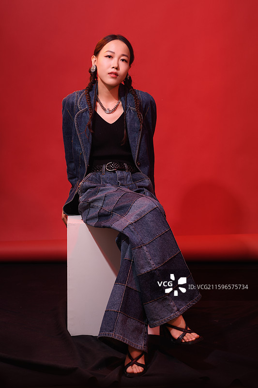 在红色背景下的年轻女子时尚肖像图片素材