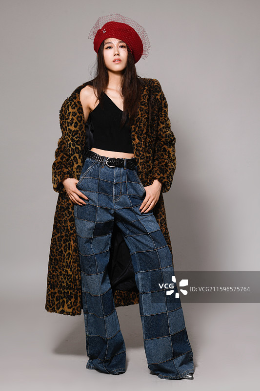 戴帽子穿豹纹大衣的年轻女子全身像图片素材