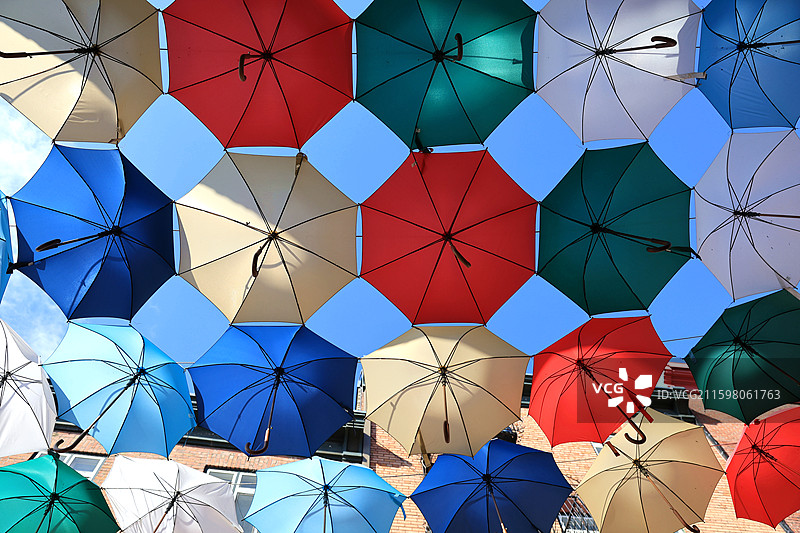 悬挂着的五颜六色明亮的雨伞组成的图形图片素材