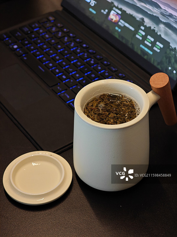 电脑前的茶杯喝茶办公图片素材