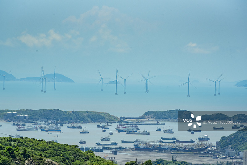 温岭石塘钓浜渔港，海岛环绕，渔船云集，风力发电机点缀海面，展现自然与人文和谐。图片素材