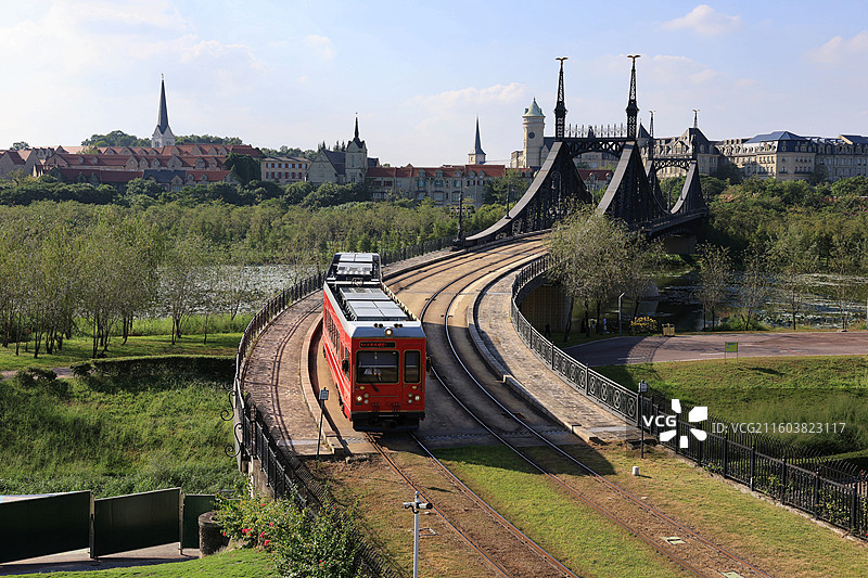 广东松山湖欧洲小镇，红色小火车驶过桥梁图片素材